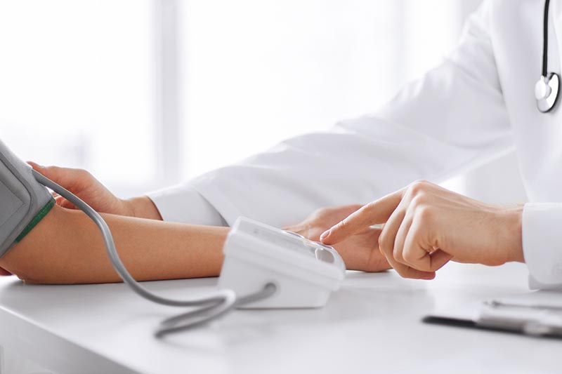 doctor and patient measuring blood pressure