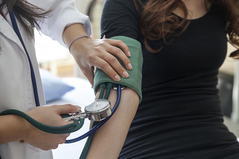 patient getting his blood pressure taken by a doctor